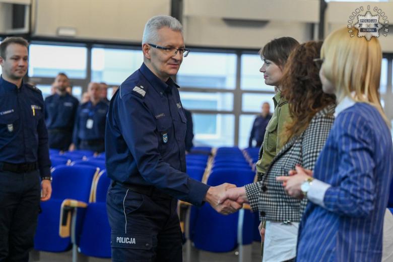 Osoba w mundurze wita się z prowadzącymi szkolenie ściskając dłoń