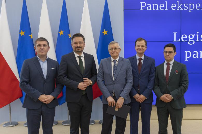 pięć osób pozuje do zdjęcia na stojąco 