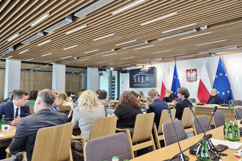 osoby siedzą w sali 