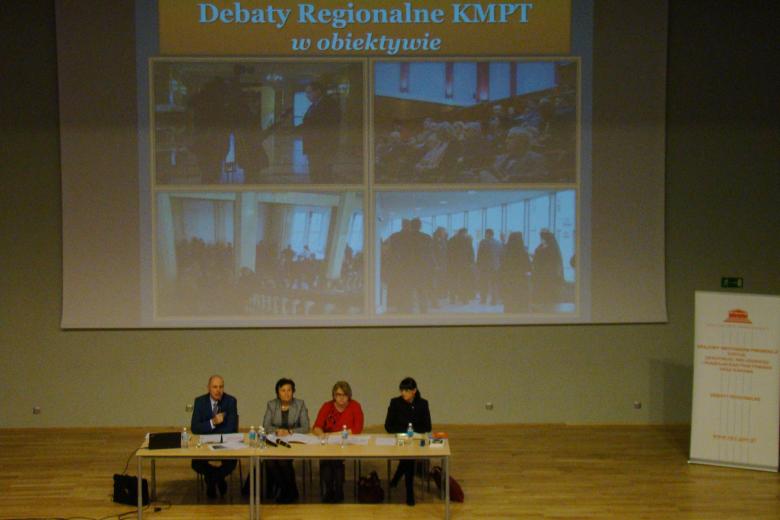 zdjęcie: na scenie przy stole siedzą trzy kobiety i mężczyzna