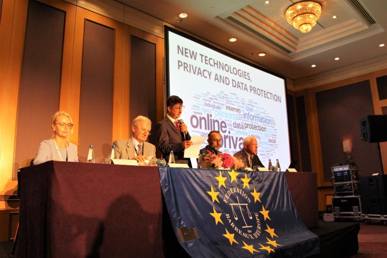 Osoby siedzą za stołem 