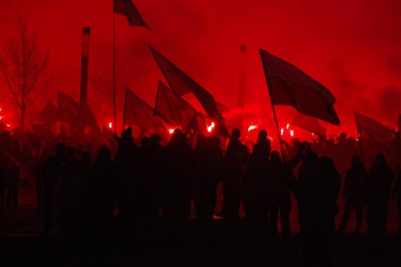 manifestanci na ulicy w ciemnym świetle