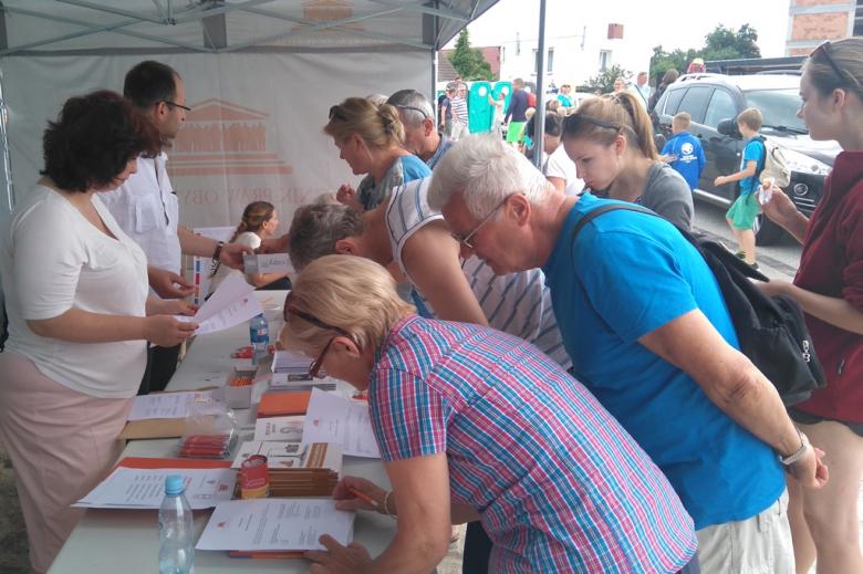 Zdjęcie: ludzie przed namiorem RPo na plaży