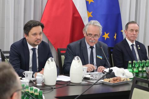 RPO Marcin Wiącek, przewodniczący Zespołu senator Leszek Czarnobaj oraz marszałek Senatu Tomasz Grodzki siedzący za stołem. W tle flagi Polski i Unii Europejskiej