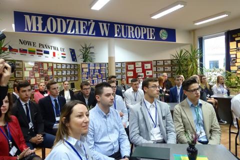 Zdjęcie: młodzi ludzie sluchają, w tle napis Młodzież w Europie